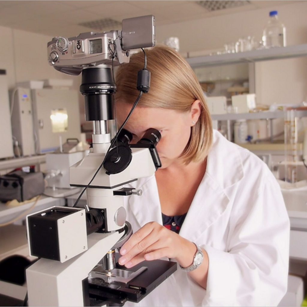 Scientist researching structured water benefits in a lab, showcasing Flaska’s TPS water structuring technology